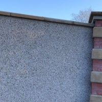 Brick pillar with stone quoins